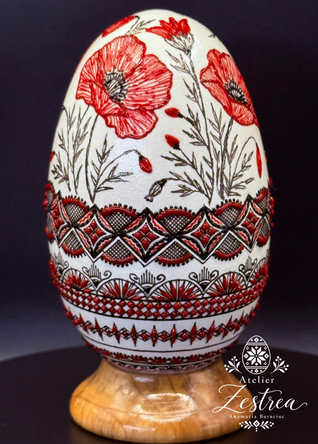 White goose egg with red poppies and black-and-red geometric bands