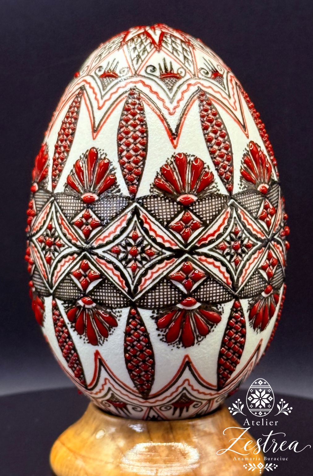 Goose egg with red fan motifs and intricate black geometric bands