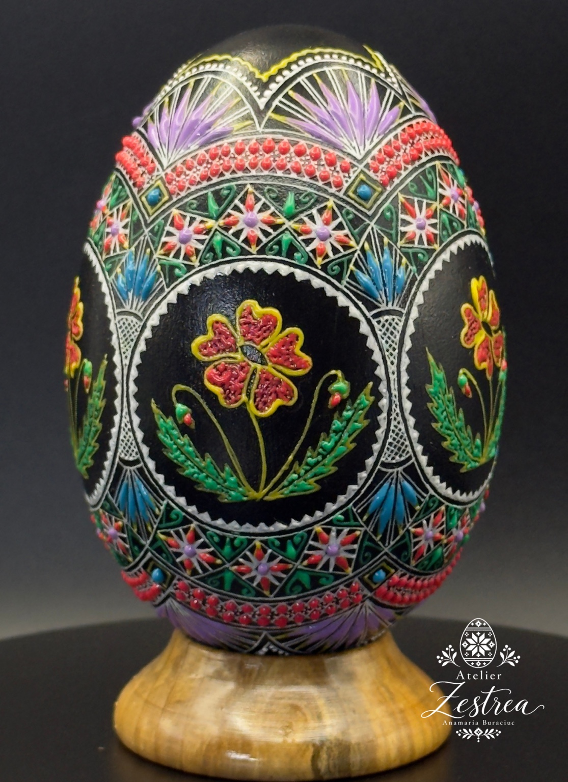 Black goose egg with colourful flowers in oval medallions and geometric borders