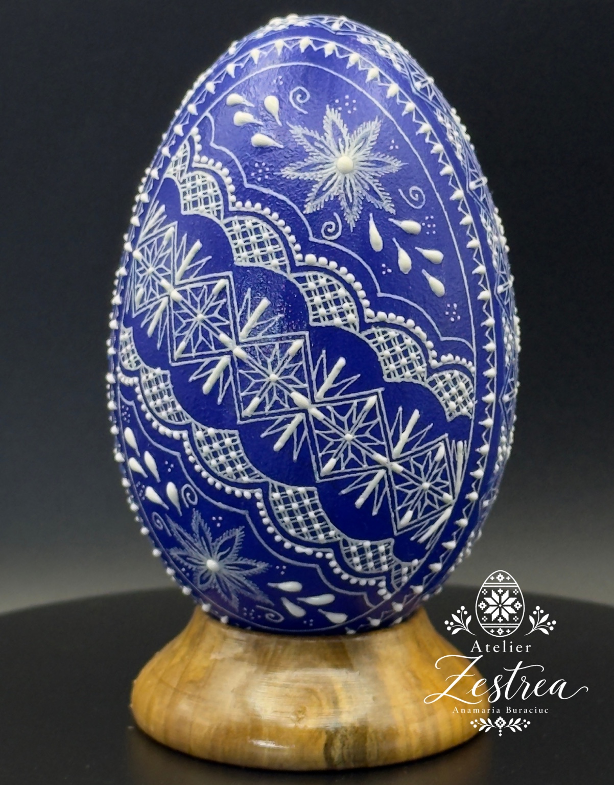 Blue goose egg with white flowers, stars and scalloped raised-wax bands