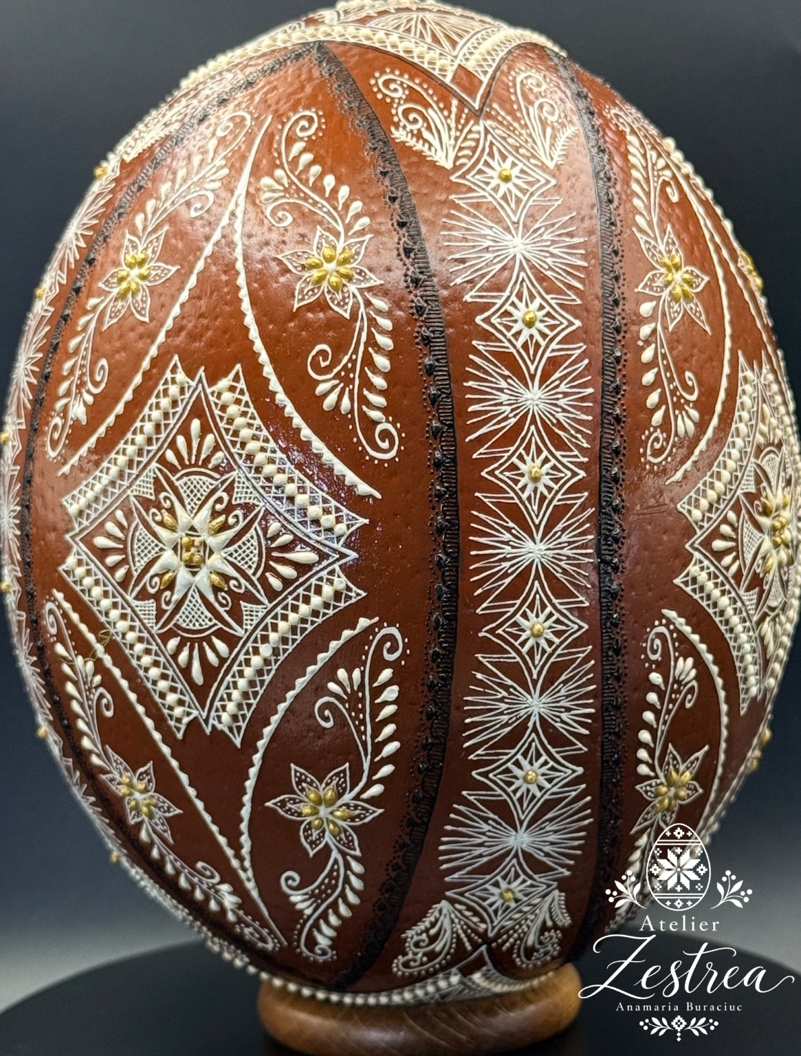 Brown ostrich egg with fine white stars, leaves and flowing raised-wax ornaments