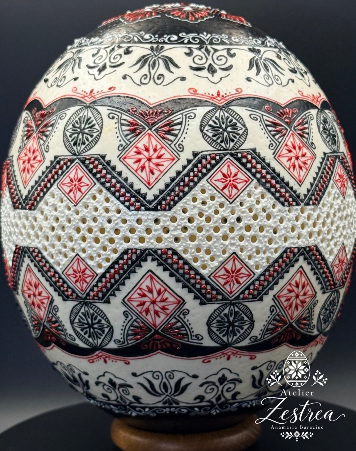 Ivory ostrich egg with red-and-black diamonds, zigzags and floral scrolls