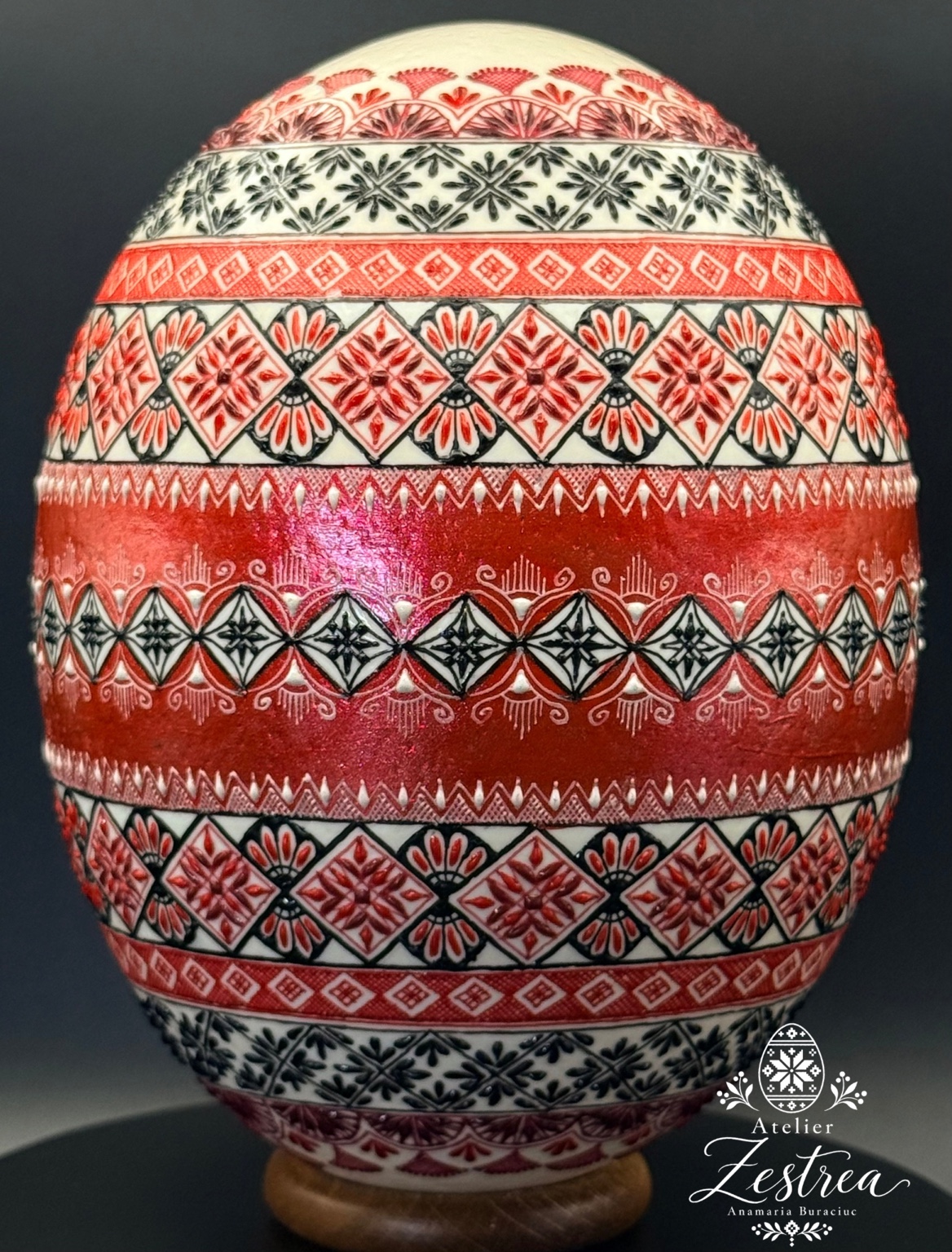 Red ostrich egg with alternating black-and-white geometric and floral bands