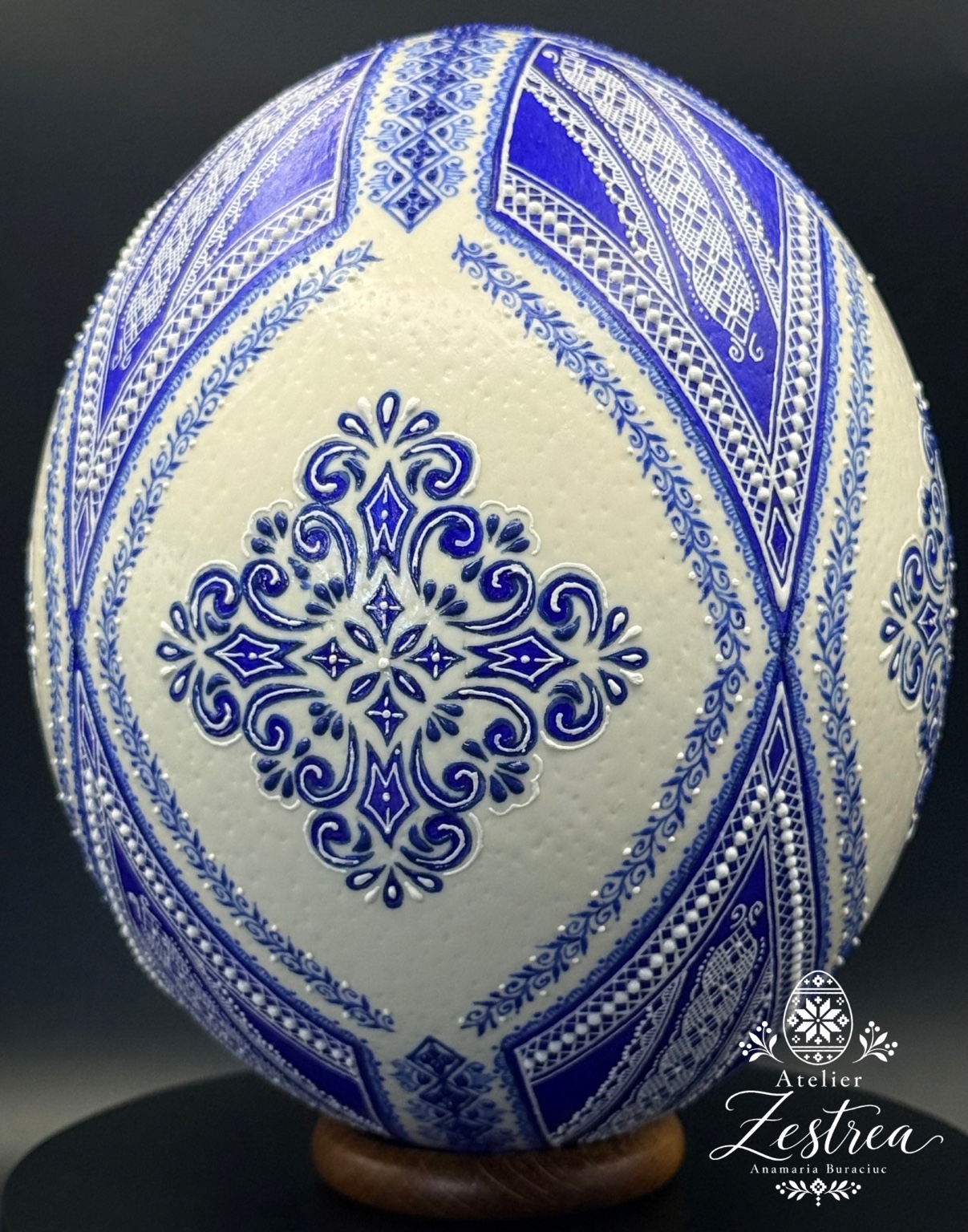 Ivory ostrich egg with blue floral medallions and curved blue-and-gold wax borders
