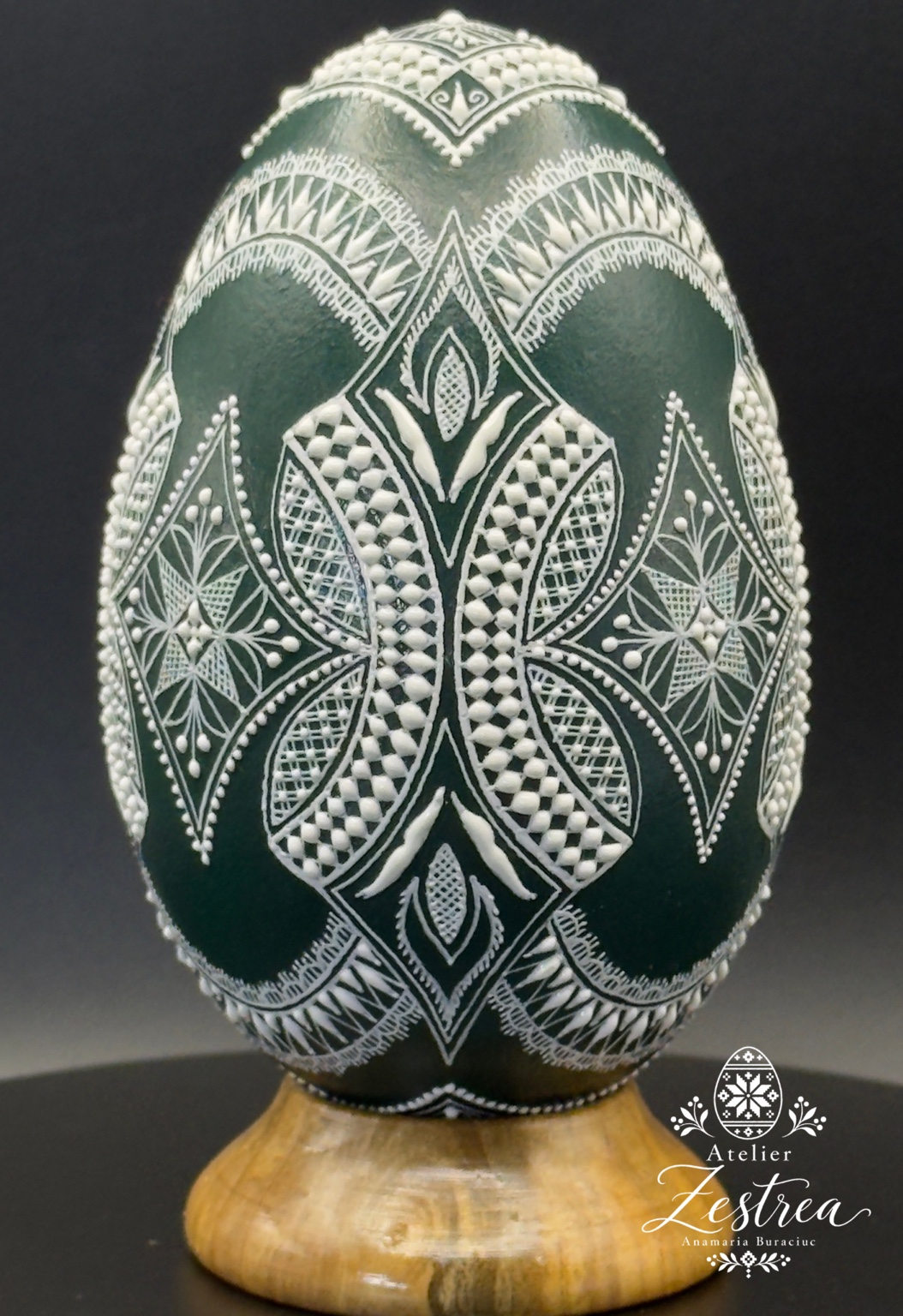Dark green goose egg with fine white raised-wax leaves and geometric ornaments