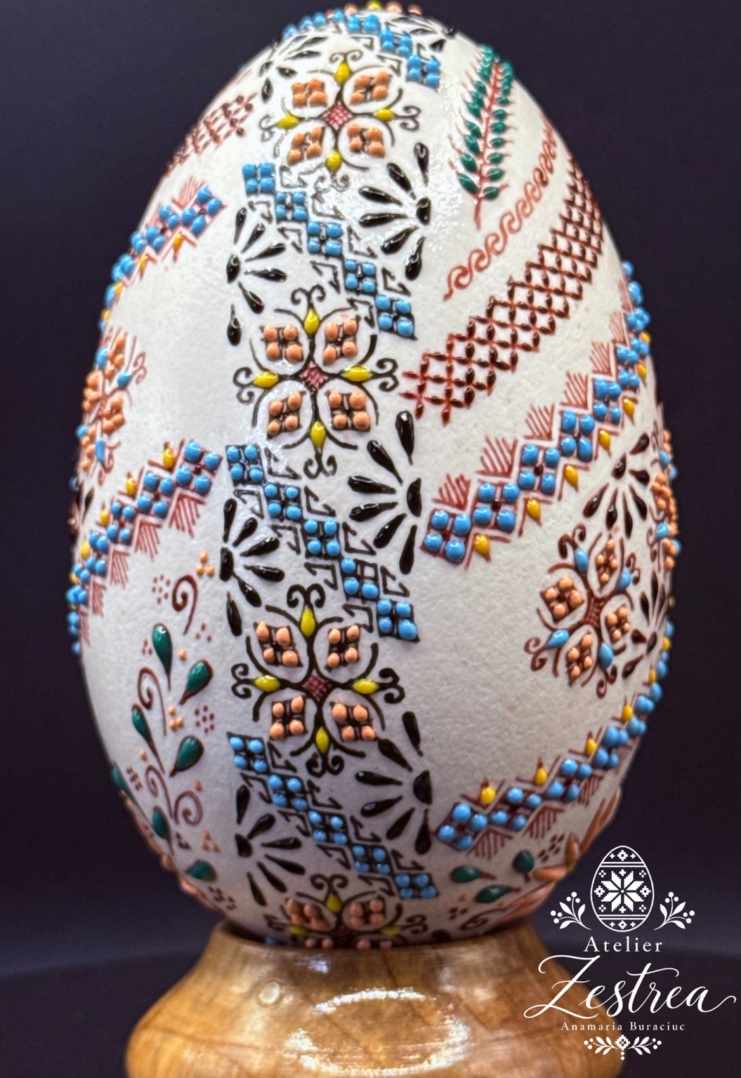 Goose egg with diagonal blue and orange bands, flowers and leafy motifs
